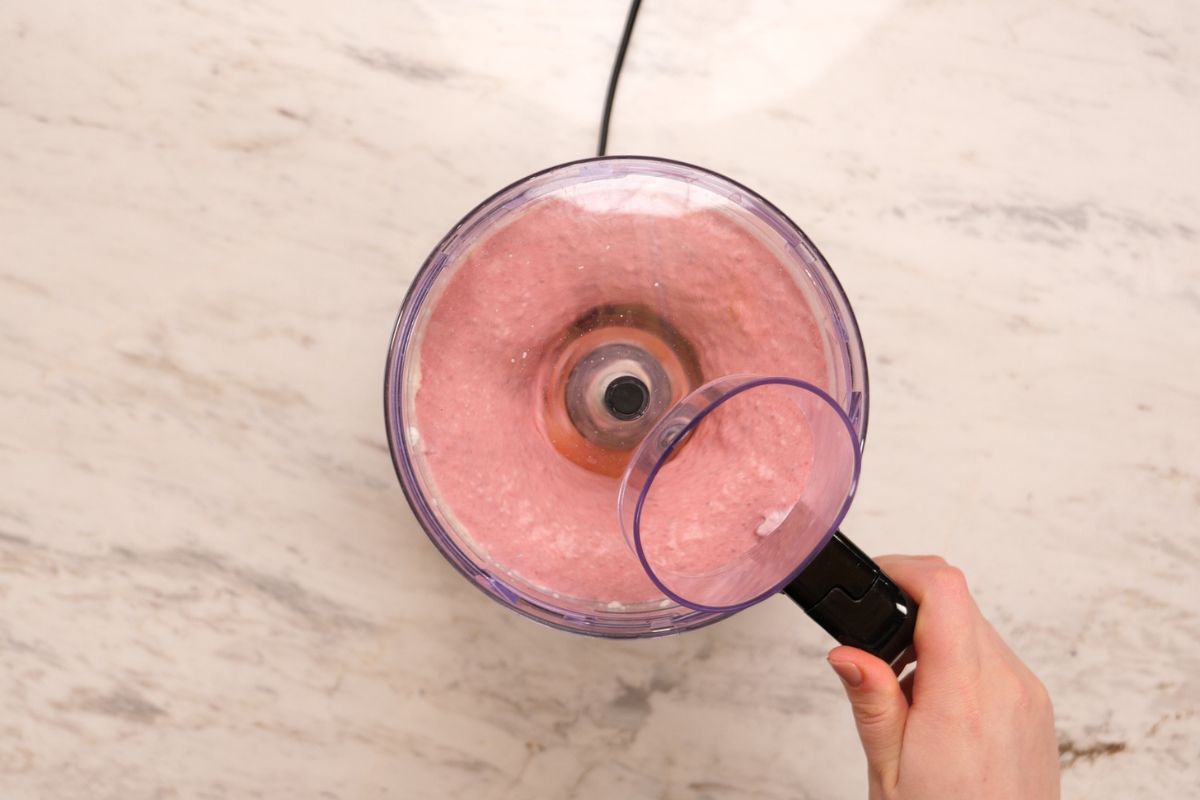 High-Protein Cottage Cheese Strawberry Mousse 6 Blending cottage cheese and strawberries into a smooth pink mousse mixture.