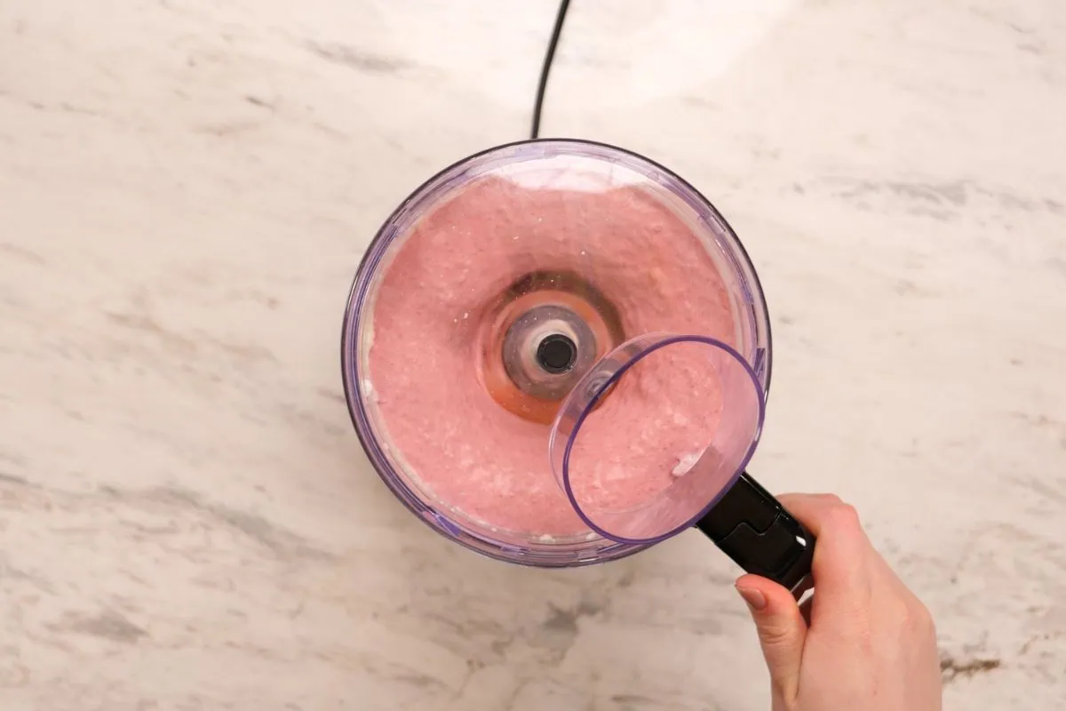 High-Protein Cottage Cheese Strawberry Mousse 6 Blending cottage cheese and strawberries into a smooth pink mousse mixture.
