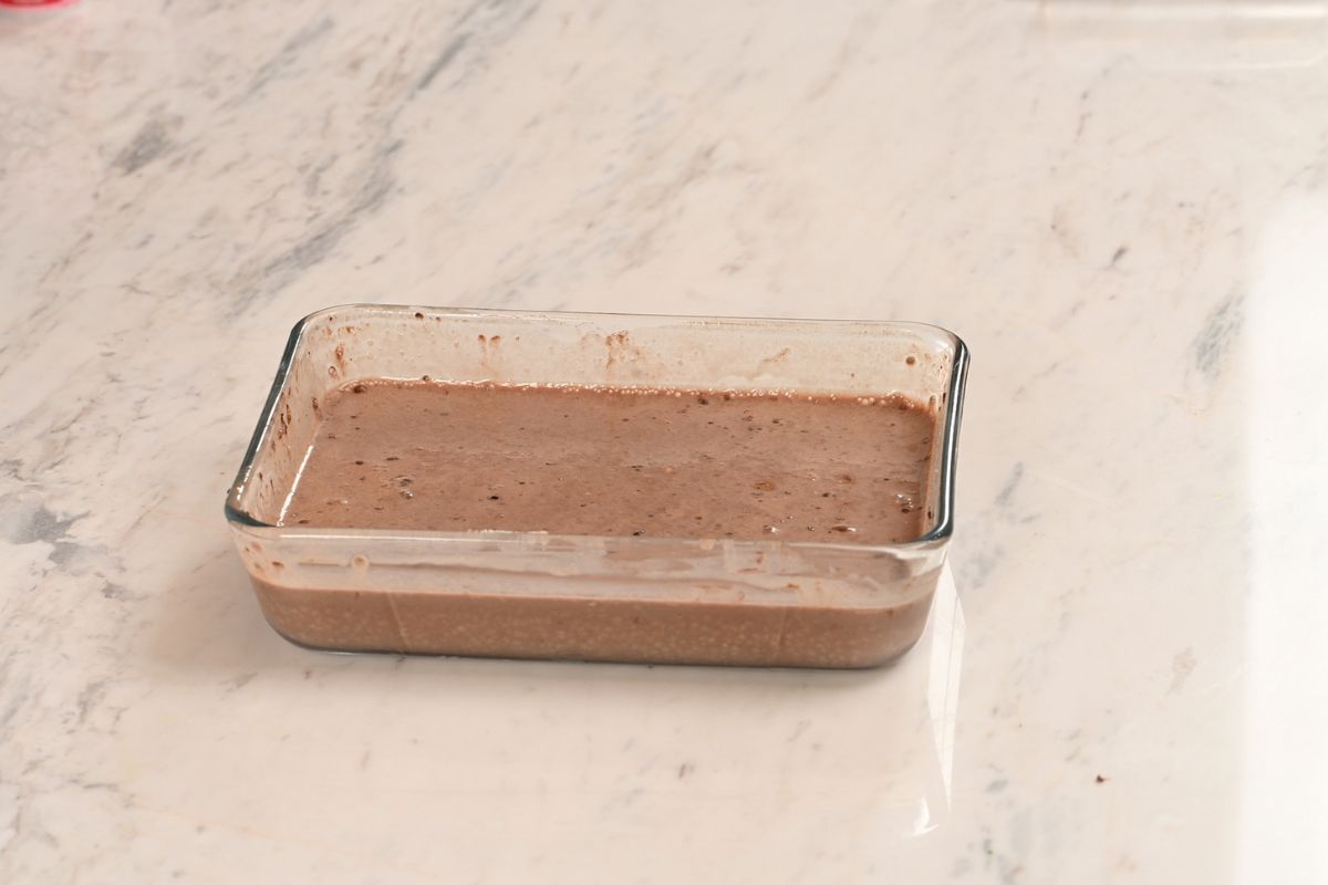 High Protein Tiramisu Chia Pudding 5 Chocolate chia pudding mixture stirred until smooth in a rectangular glass container.