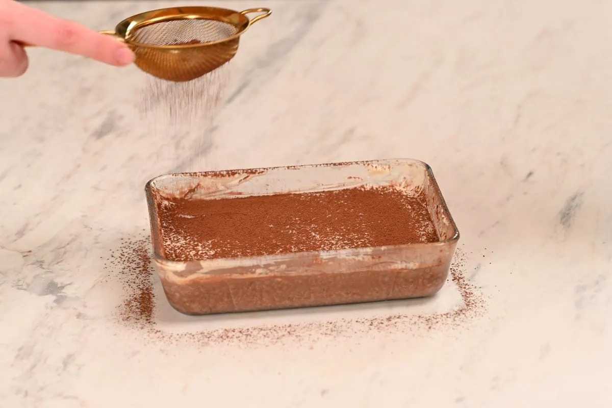 High Protein Tiramisu Chia Pudding 6 Dusting cocoa powder over high protein tiramisu chia.