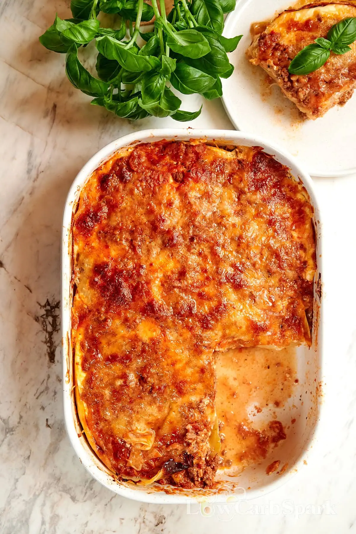 High-Protein Cabbage Lasagna 12 Baked cabbage lasagna in a casserole dish with a slice removed.