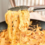 Close up of creamy cabbage pasta coated in sun-dried tomato parmesan sauce.