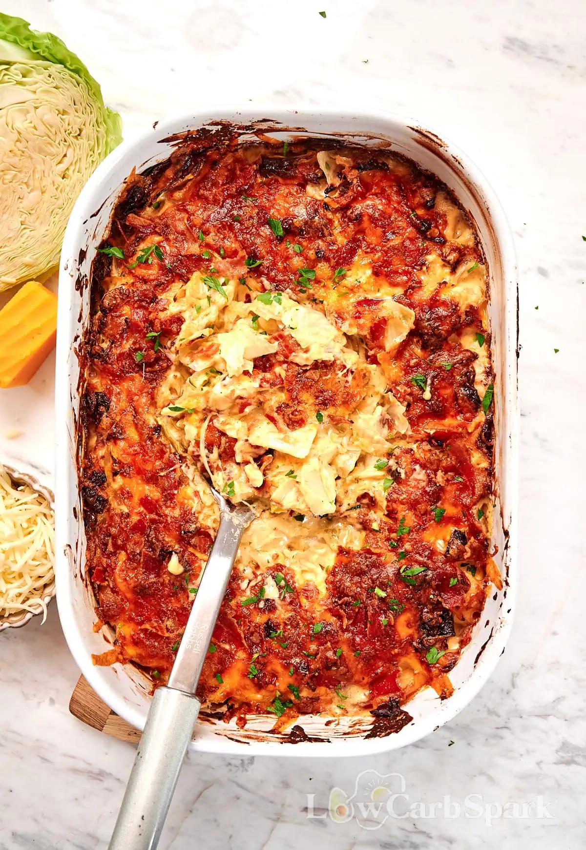 Creamy Cabbage Mac and Cheese 2 Baked creamy cabbage mac and cheese casserole topped with crispy bacon and fresh parsley in a white dish