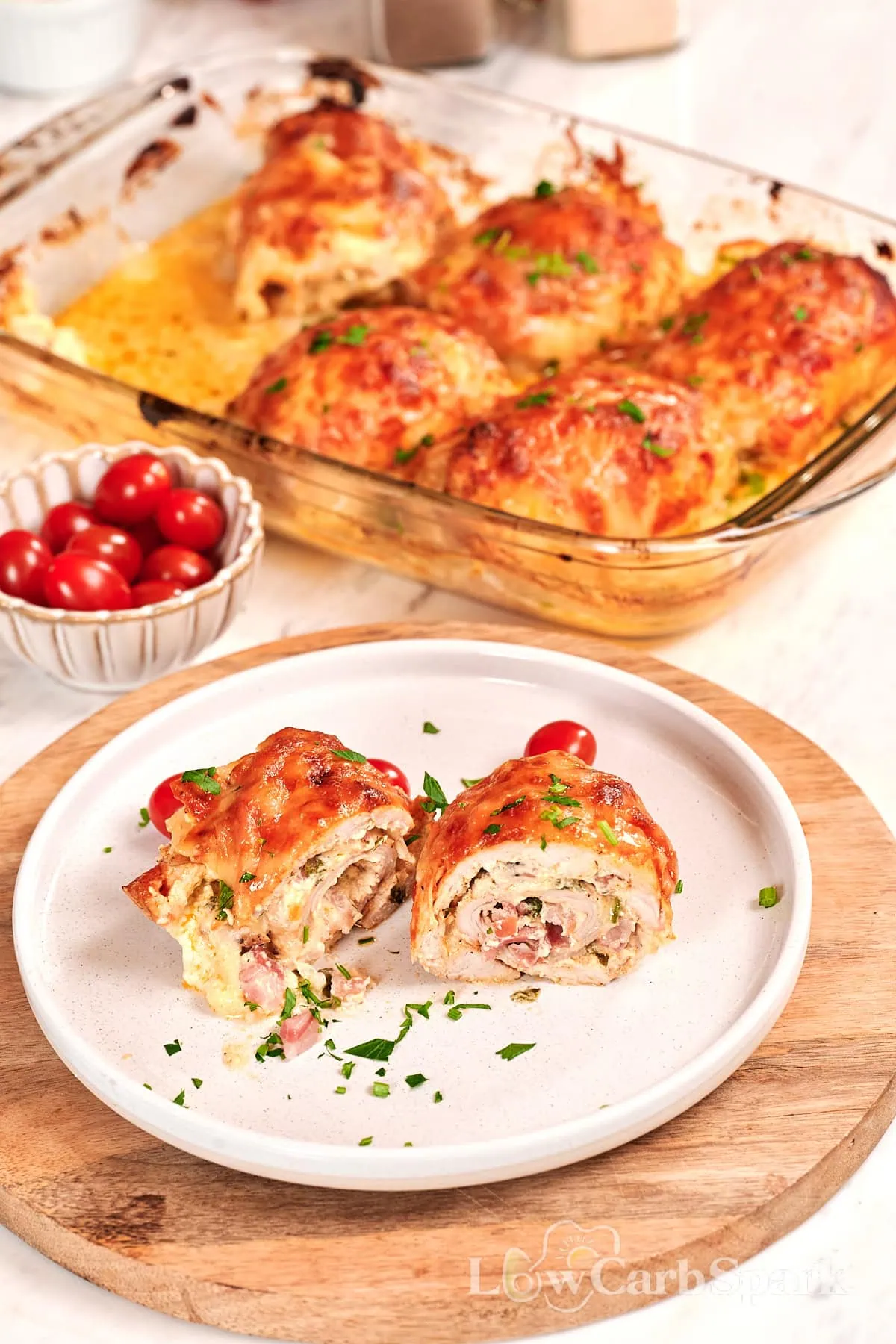 Famous Chicken Breast Rolls 1 Sliced chicken breast roll with creamy filling served on a plate with melted cheese and herbs