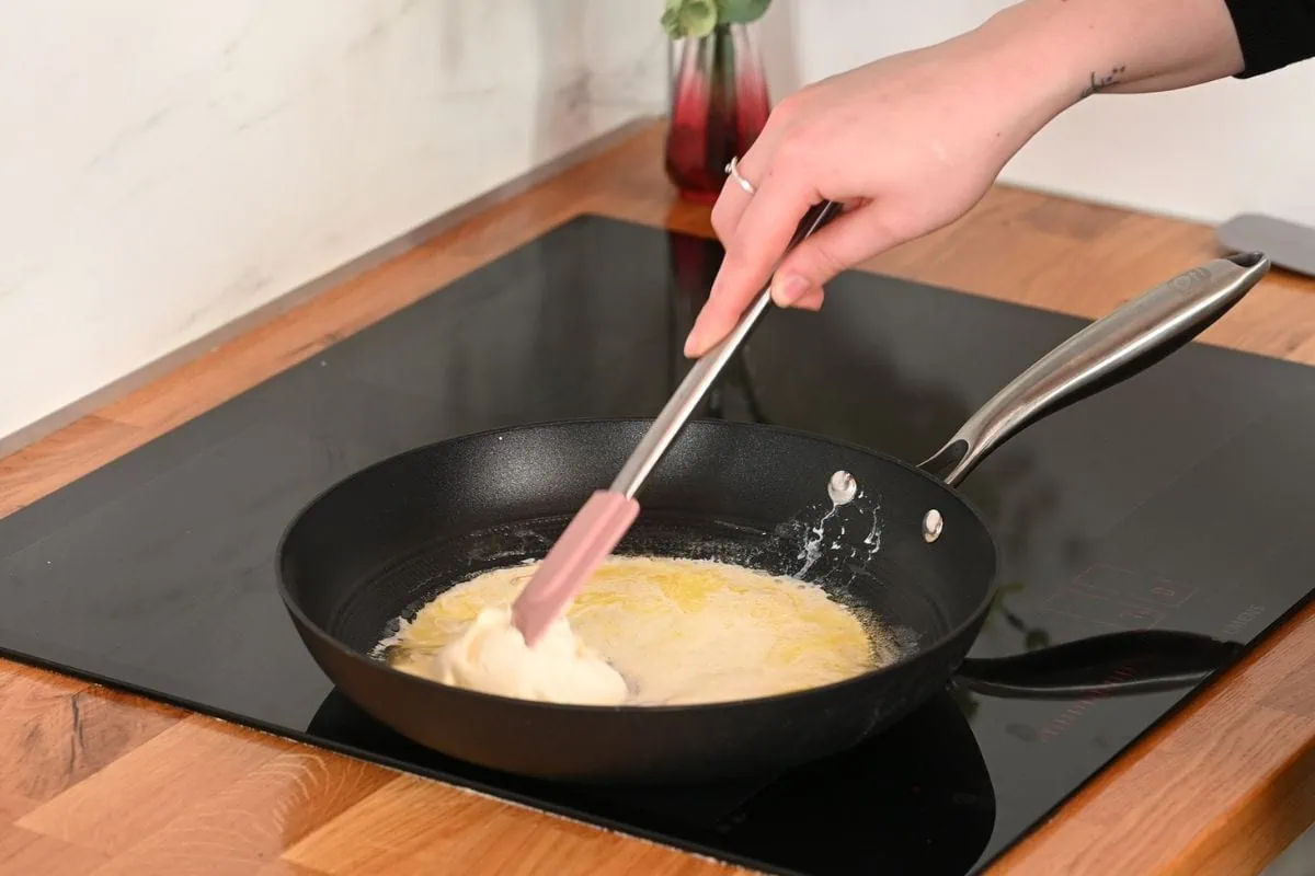 Creamy Cabbage Mac and Cheese 5 Melting butter and cream cheese in a skillet to make sauce for creamy cabbage mac and cheese