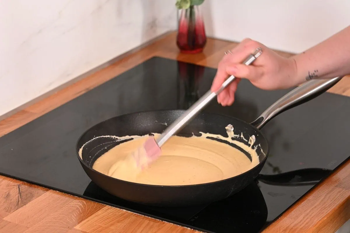 Creamy Cabbage Mac and Cheese 7 Smooth and creamy cheese sauce cooking in a pan for cabbage mac and cheese