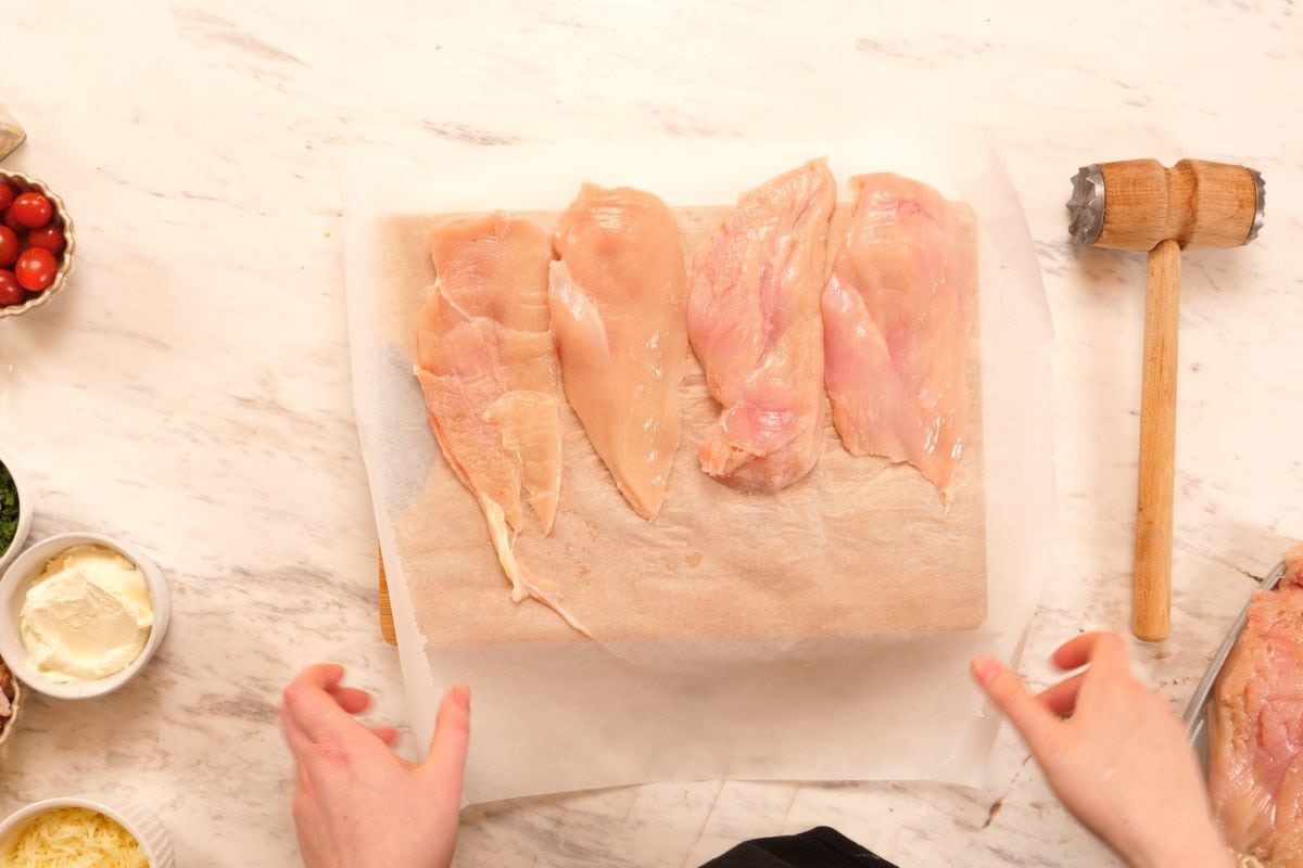 Famous Chicken Breast Rolls 4 Raw chicken breasts prepared on board for stuffed chicken breast rolls recipe