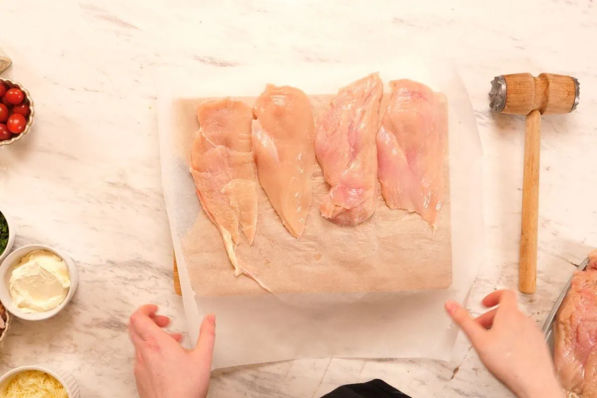 Famous Chicken Breast Rolls 4 Raw chicken breasts prepared on board for stuffed chicken breast rolls recipe