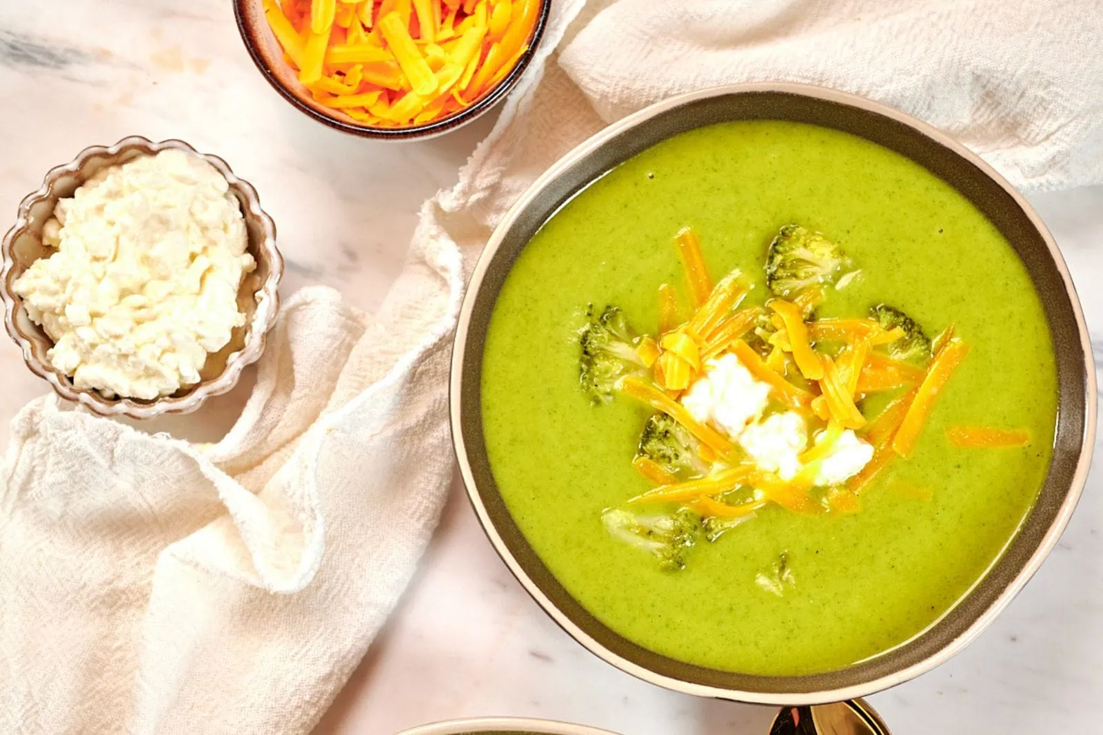 High-Protein Broccoli Soup (Creamy & Easy) 1 A cozy high-protein broccoli cheddar soup made with cottage cheese, bone broth, broccoli, cauliflower, spinach, and sharp cheddar.