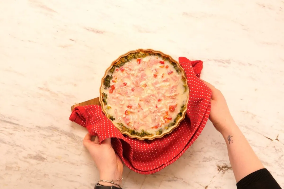 Cheesy Broccoli Crust Quiche 7 Unbaked cheesy broccoli crust quiche filled with ham and egg mixture before baking.