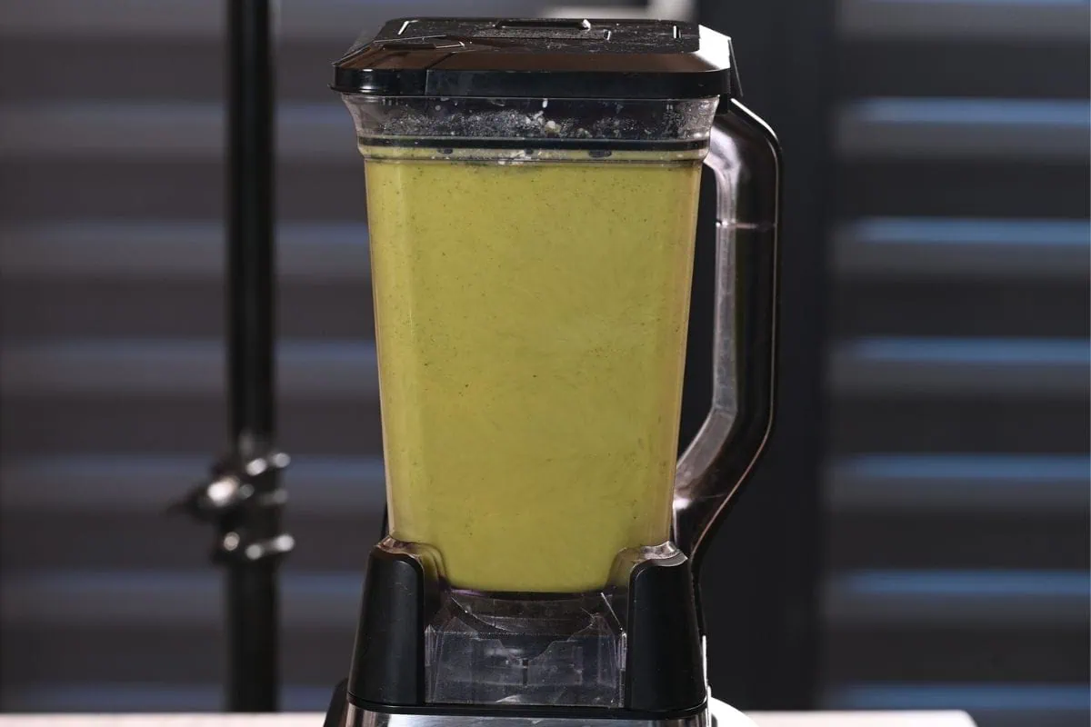 High-Protein Broccoli Soup (Creamy & Easy) 9 Creamy blended high-protein broccoli soup in a blender ready to serve.