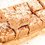 No-bake peanut butter Greek yogurt protein bars topped with shredded coconut, showing their creamy texture and peanut butter flavor.