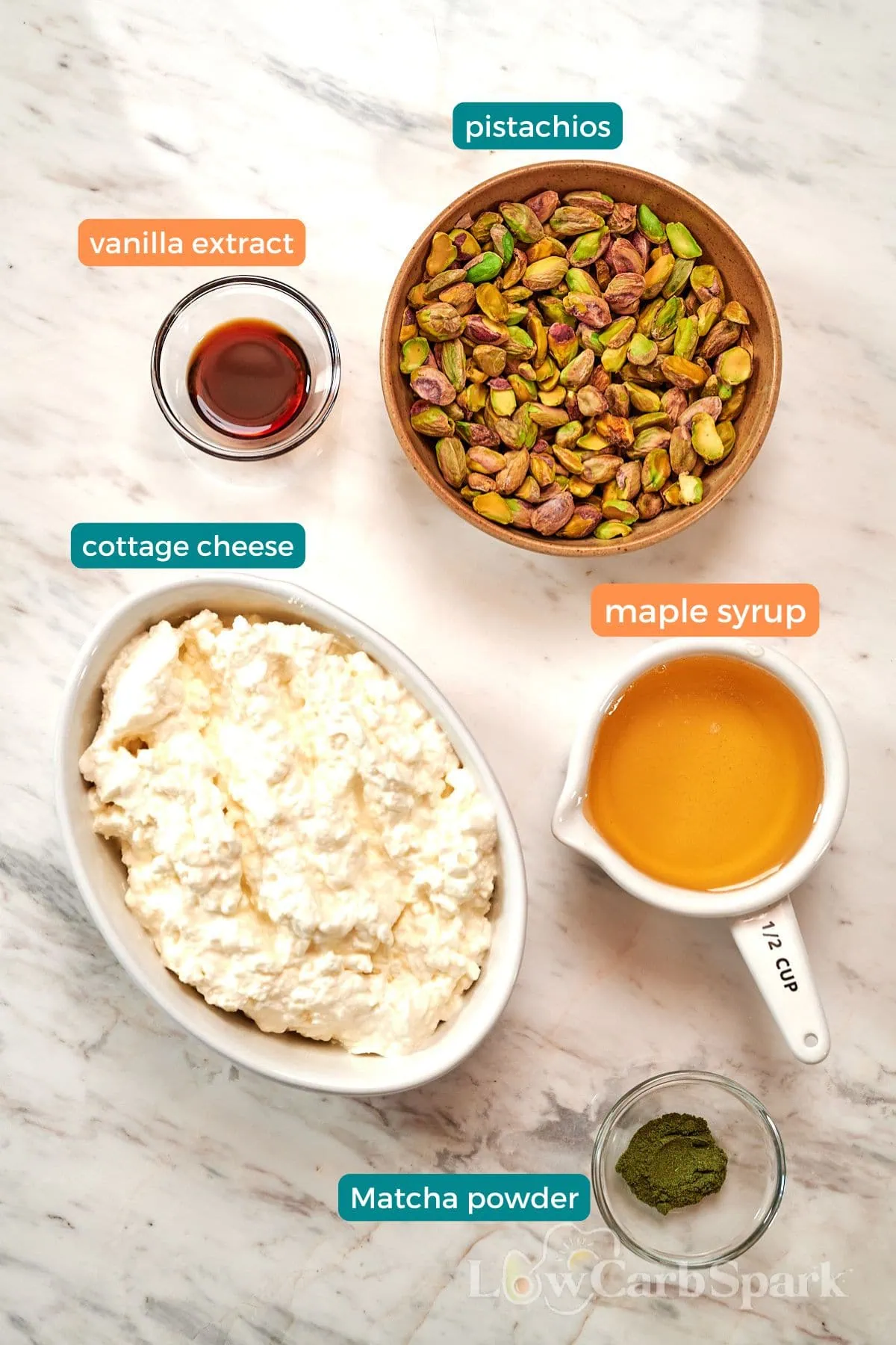 4-Ingredient Pistachio Cottage Cheese Ice Cream 3 Ingredients for pistachio cottage cheese ice cream, including cottage cheese, pistachios, maple syrup, vanilla extract, and matcha powder.