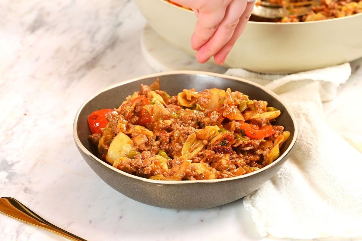 One-Pan Cajun Beef and Cabbage Skillet 14 Finished one-pan Cajun beef and cabbage skillet served in a bowl and garnished before serving.