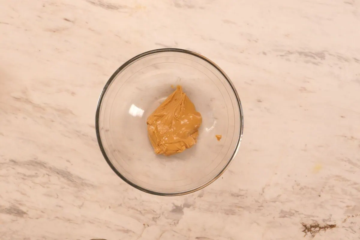 No-Bake Peanut Butter Greek Yogurt Protein Bars 5 Peanut butter in a mixing bowl ready to be combined with Greek yogurt and protein powder for no-bake bars.