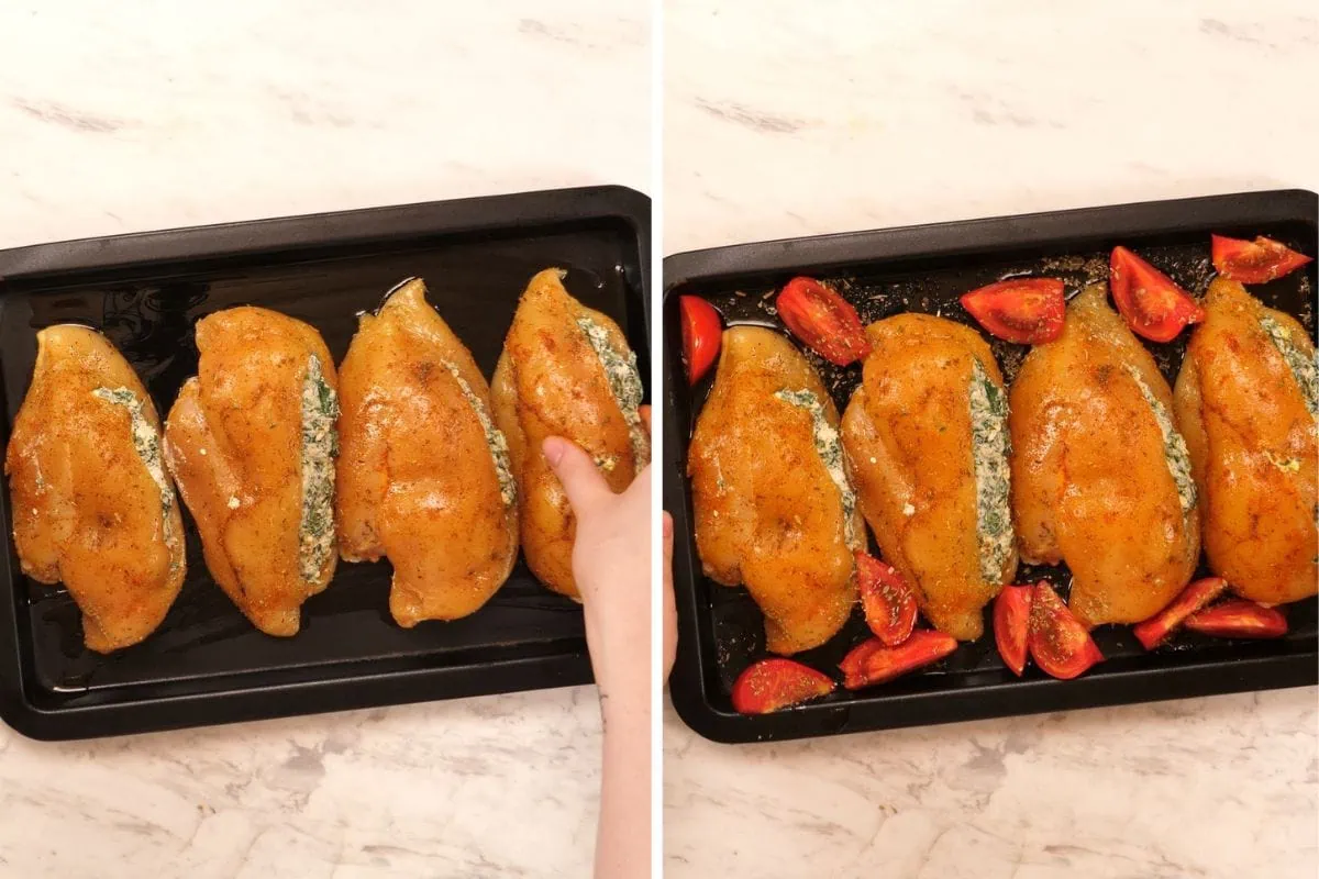 Spinach and Feta Stuffed Chicken Breast 7 Spinach and feta stuffed chicken breasts arranged on a baking sheet with fresh tomato wedges ready for roasting.