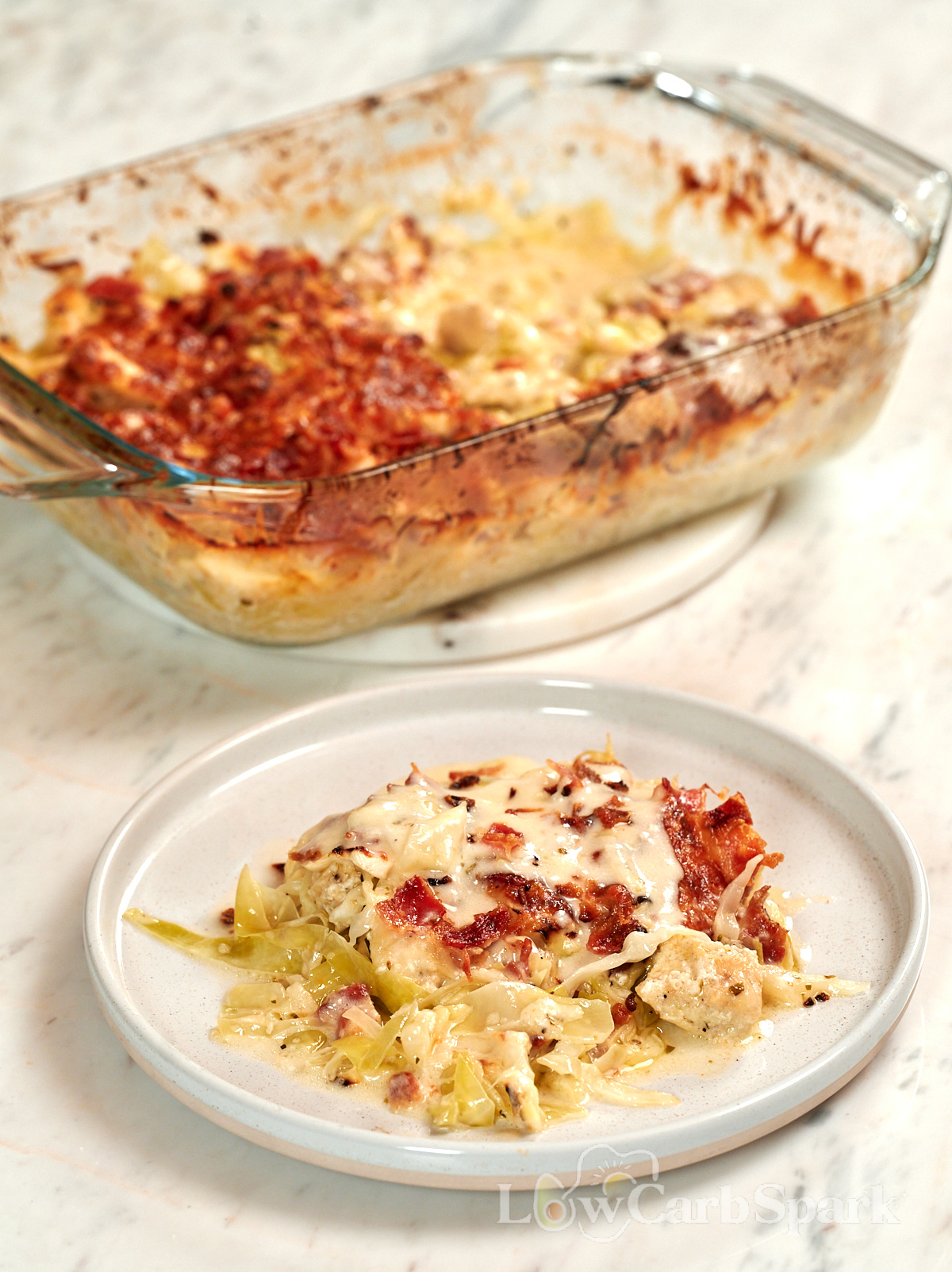Chicken Alfredo Cabbage Bake 9 Chicken Alfredo Cabbage Bake served on a plate with creamy cabbage, juicy chicken, crispy bacon, and melted cheese.