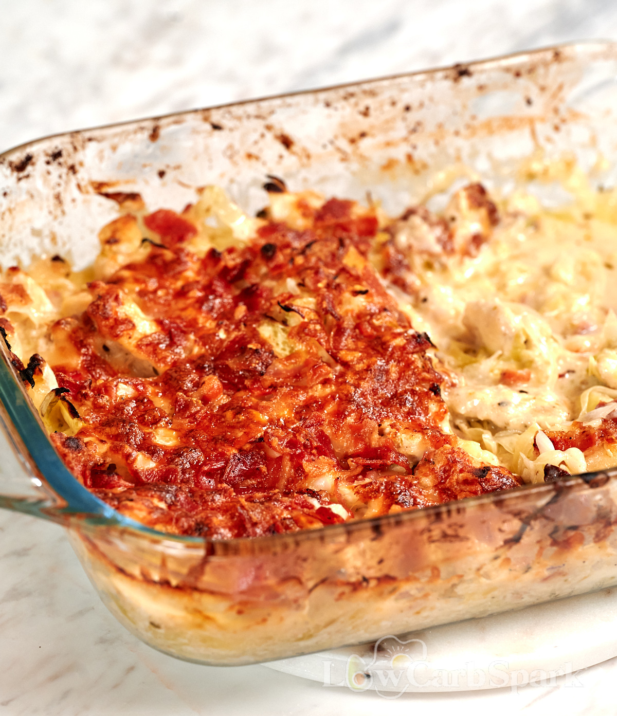 Chicken Alfredo Cabbage Bake 2 Freshly baked Chicken Alfredo Cabbage Bake with golden melted cheese, crispy bacon, creamy Alfredo sauce, and tender cabbage.
