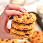 Hand holding a stack of High-Protein Cottage Cheese Breakfast Cookies loaded with chocolate chips, made with cottage cheese and wholesome ingredients for an easy high-protein breakfast or snack.