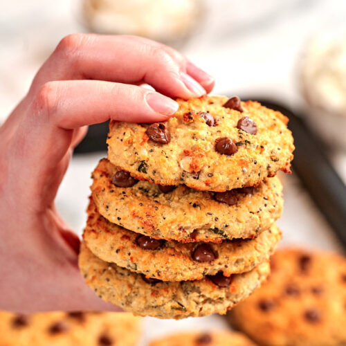 High-Protein Cottage Cheese Breakfast Cookies 5 Hand holding a stack of High-Protein Cottage Cheese Breakfast Cookies loaded with chocolate chips, made with cottage cheese and wholesome ingredients for an easy high-protein breakfast or snack.