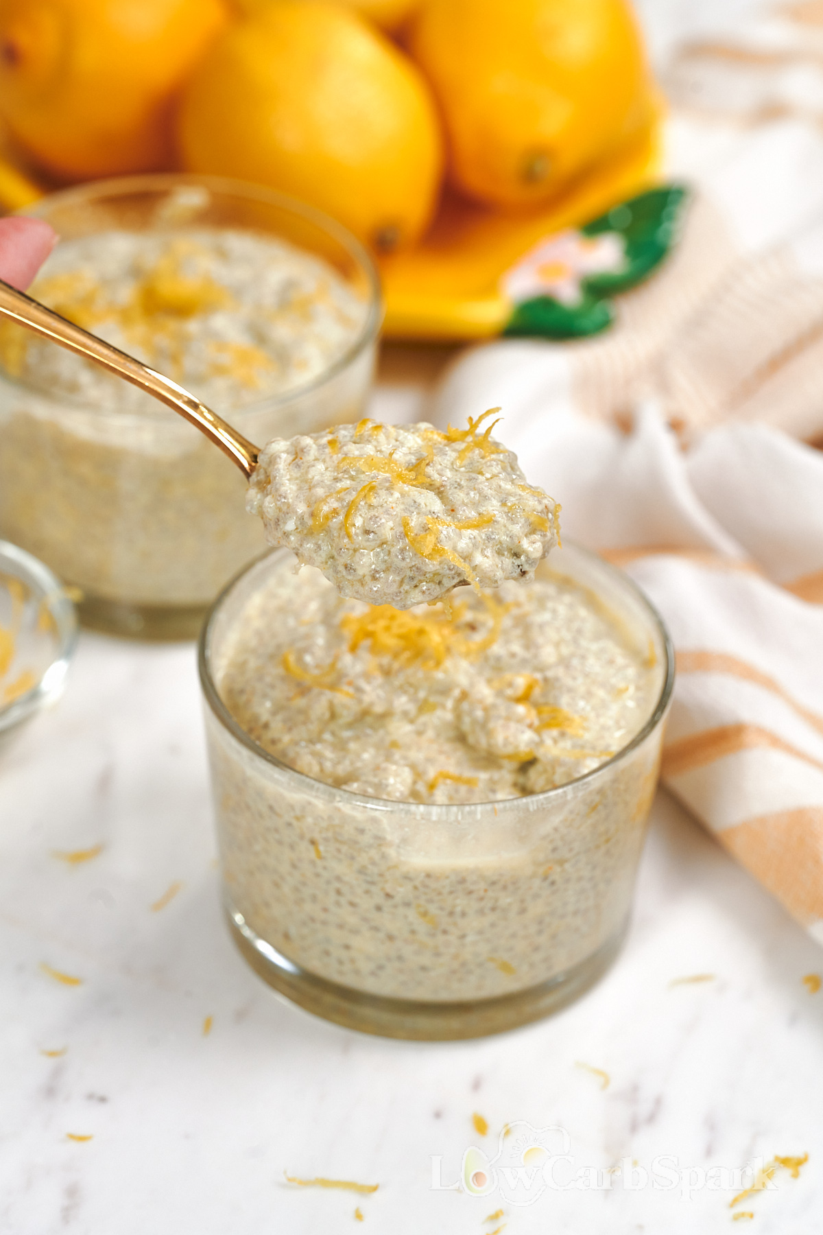 High-Protein Cottage Cheese Lemon Chia Pudding 11 Close-up of a spoon lifting creamy cottage cheese lemon chia pudding with visible chia seeds and fresh lemon zest.