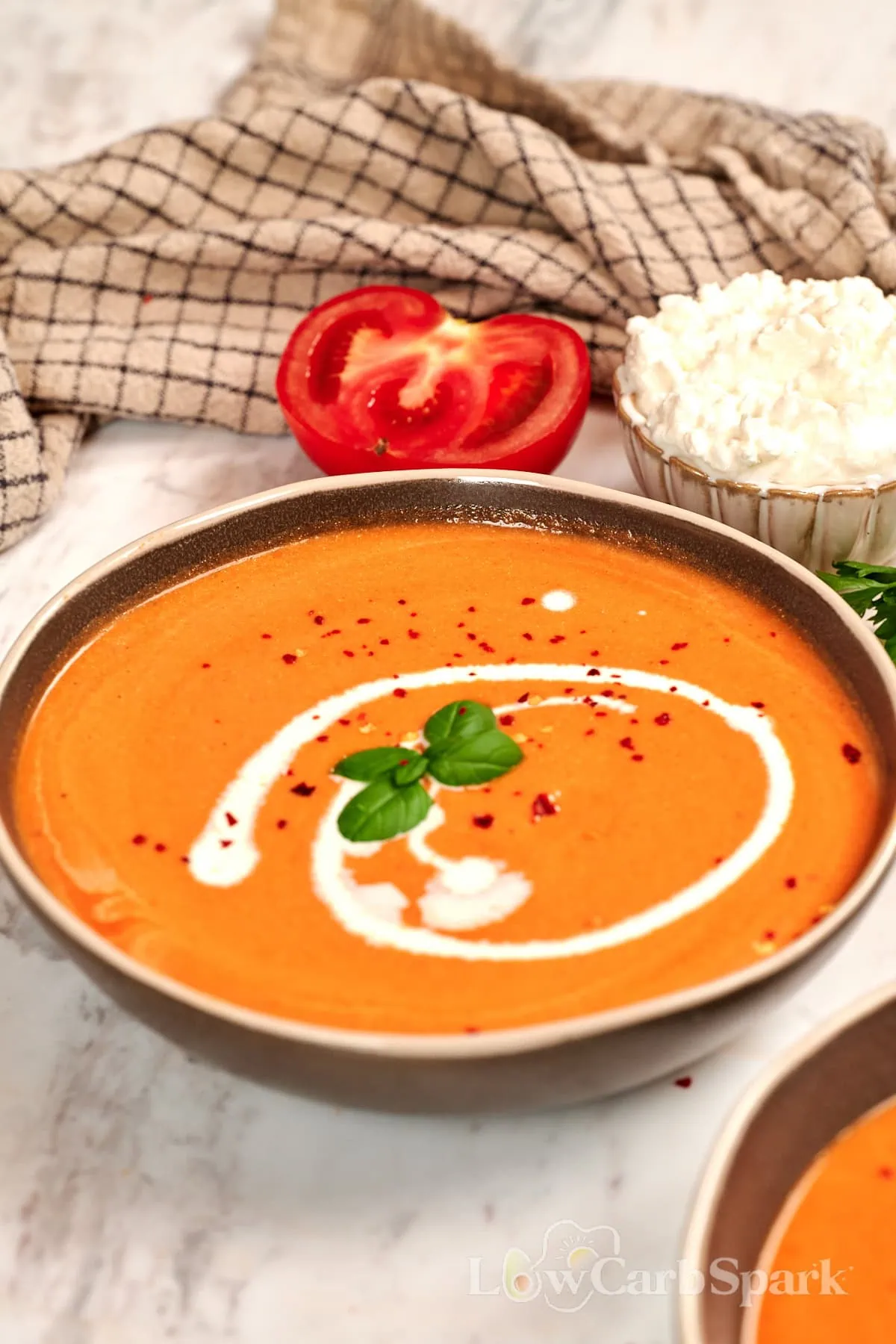 High-Protein Tomato Soup with Cottage Cheese 1 Creamy high-protein tomato soup made with roasted tomatoes and cottage cheese, topped with a swirl of cream, fresh basil, and red pepper flakes.