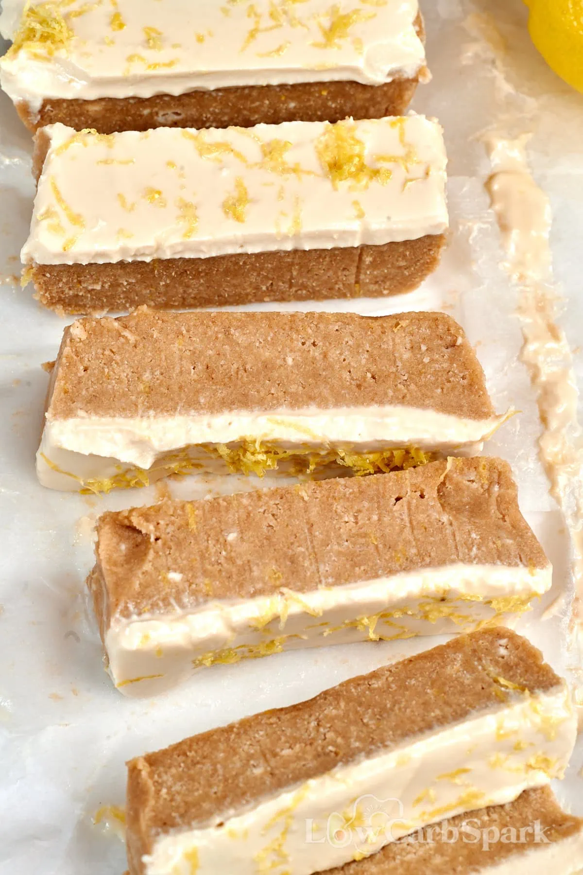 Lemon Cottage Cheese Protein Bars 2 Lemon cottage cheese protein bars topped with creamy lemon frosting and fresh lemon zest.