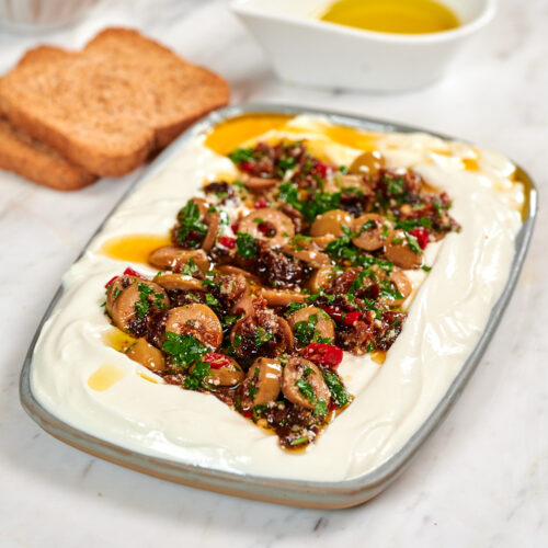 Whipped Cottage Cheese Dip with Sun-Dried Tomatoes 5 Creamy whipped cottage cheese dip topped with sun-dried tomatoes, green olives, garlic, fresh parsley, Parmesan, and olive oil, served with toasted bread.