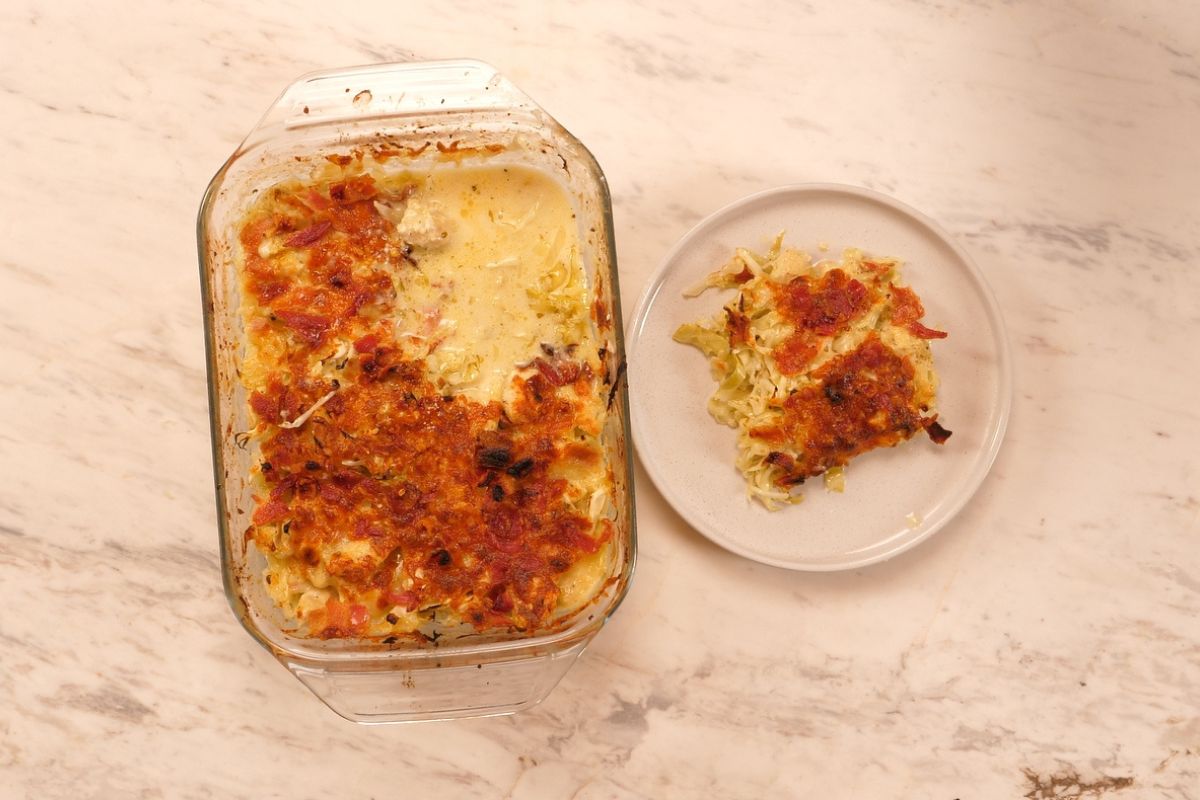 Chicken Alfredo Cabbage Bake 8 Chicken Alfredo Cabbage Bake served from the baking dish with one creamy, cheesy portion plated.