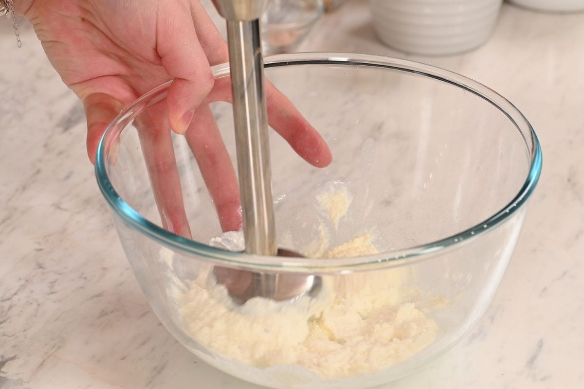 Lemon Cottage Cheese Protein Bars 5 Blending cottage cheese with an immersion blender until smooth for lemon cottage cheese protein bars.