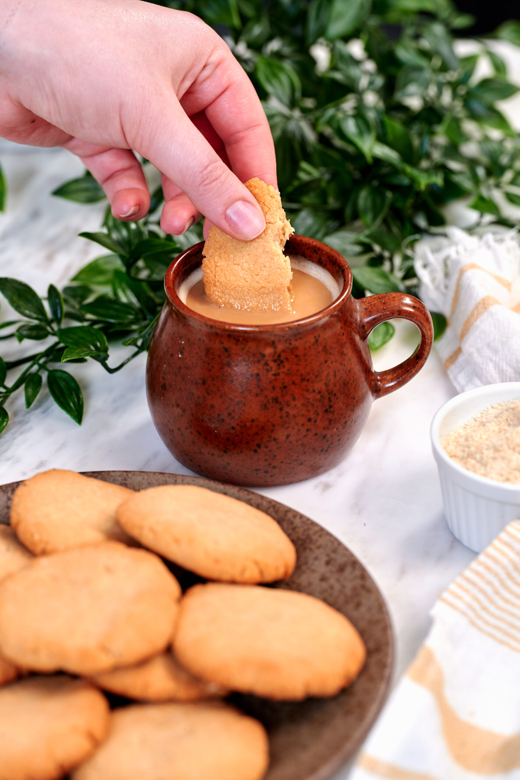 2 Ingredient Almond Flour Cookies 9 Hand dipping a 2 ingredient almond flour cookie into a warm cup of coffee