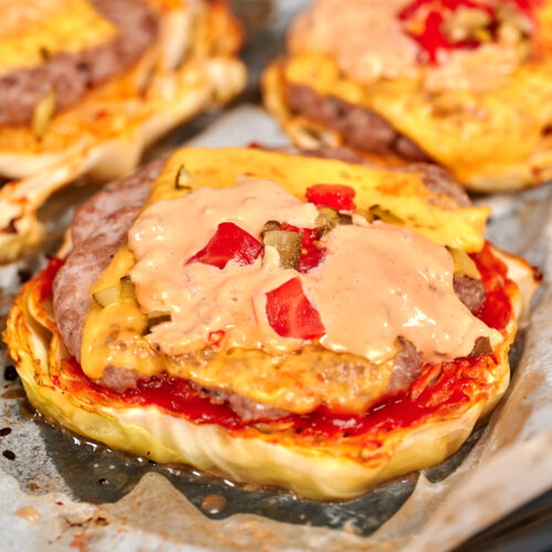 Cabbage Cheeseburgers 16 Cabbage cheeseburger topped with melted cheese, pickles, tomatoes, and creamy burger sauce on a roasted cabbage slice.