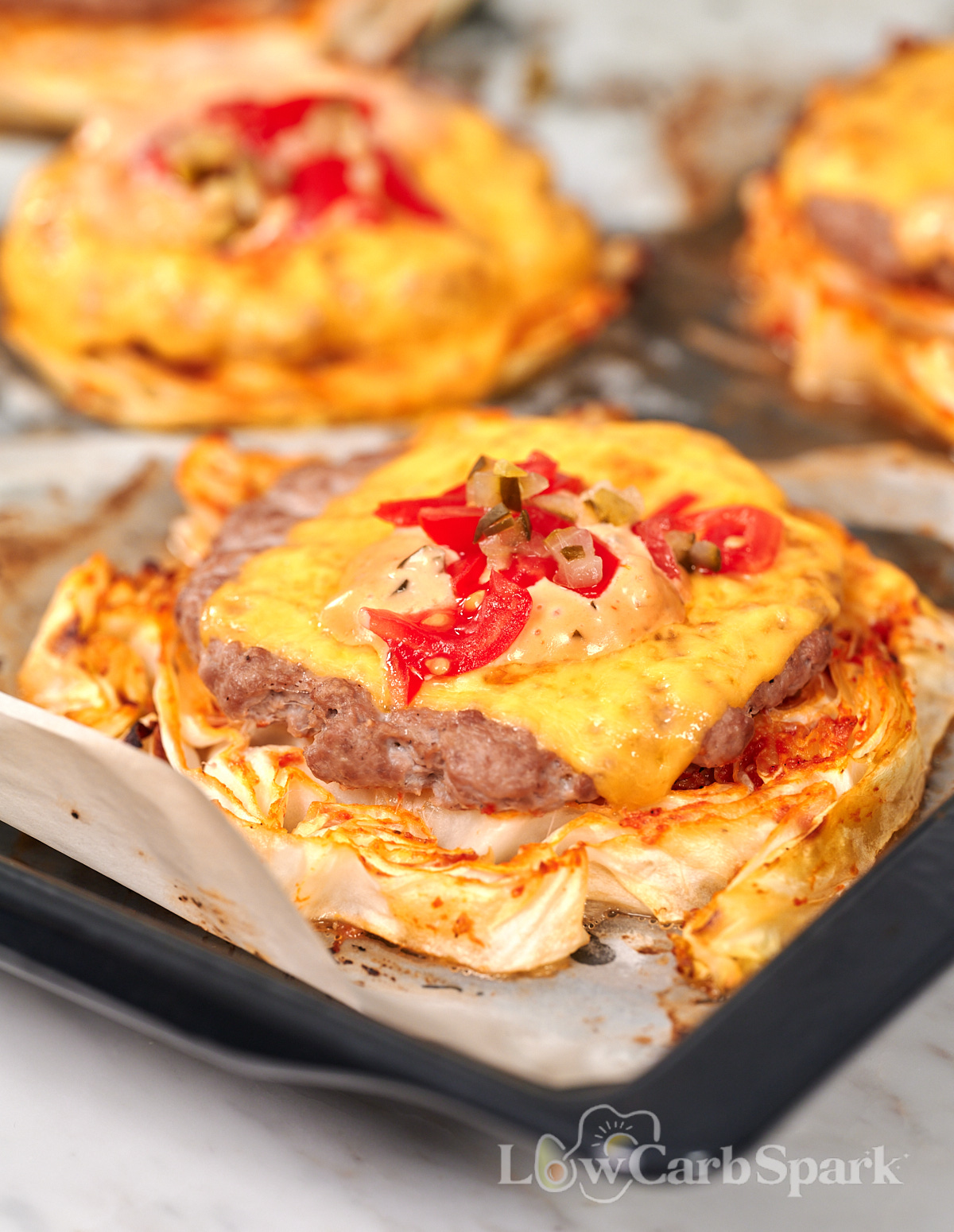 Cabbage Cheeseburgers 15 Cabbage cheeseburger with melted cheddar, chopped pickles, tomatoes, and creamy sauce on a roasted cabbage base.