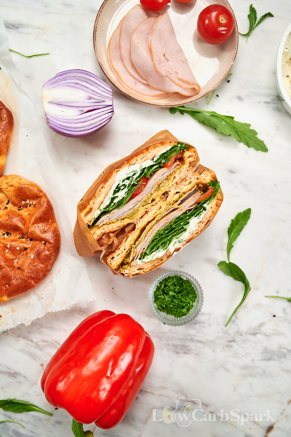 Cottage Cheese Psyllium Buns 13 Cottage cheese psyllium bun sandwich with turkey, arugula, tomato, and creamy spread served with fresh vegetables.
