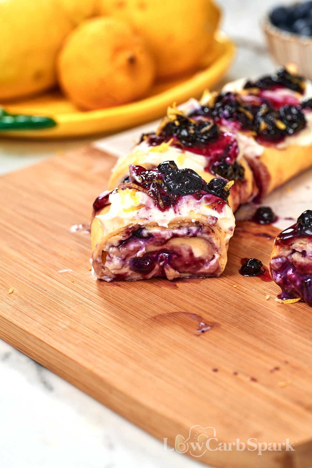 Cottage Cheese Blueberry Roll 1 High protein cottage cheese blueberry roll topped with cream cheese, blueberry sauce, fresh blueberries, and lemon zest.