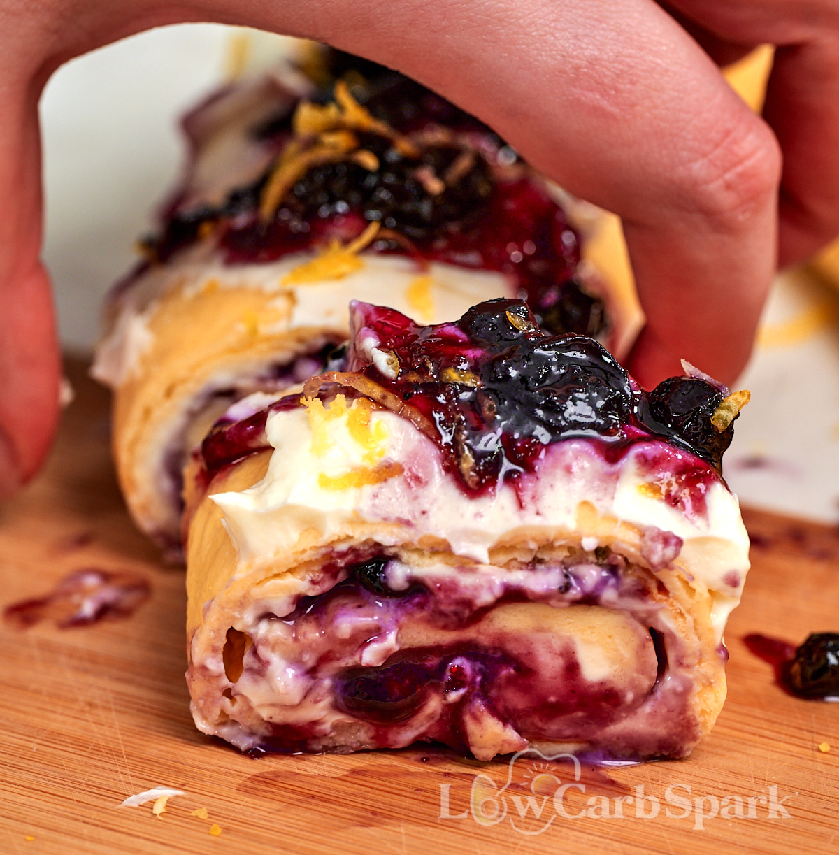Cottage Cheese Blueberry Roll 14 Close up of a high protein cottage cheese blueberry roll showing the creamy filling and blueberry swirl inside.
