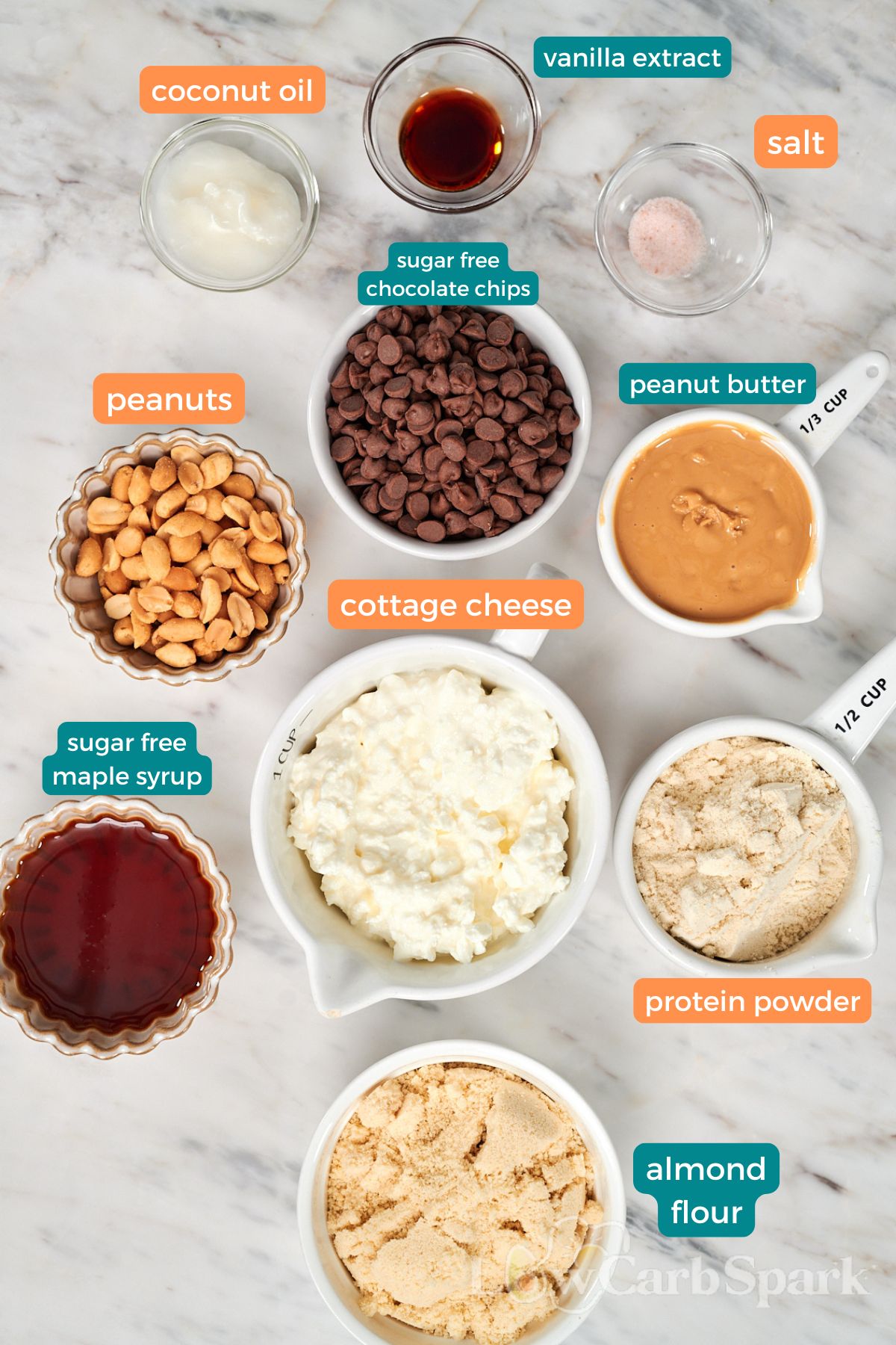 Cottage Cheese Snickers Bars 2 Ingredients for high protein cottage cheese Snickers bars, including cottage cheese, peanut butter, chocolate chips, peanuts, and protein powder.