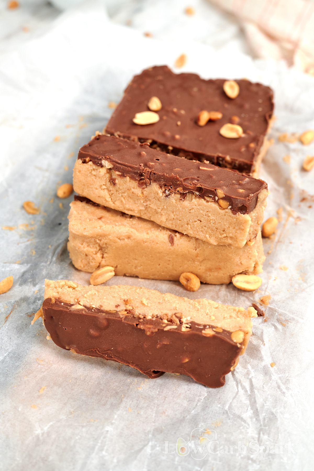 Cottage Cheese Snickers Bars 1 Stack of high protein cottage cheese Snickers bars with a creamy peanut butter layer and chocolate peanut topping.