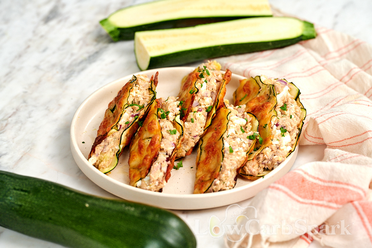 High-Protein Tuna Avocado Zucchini Tacos 12 High Protein Tuna Avocado Zucchini Tacos arranged on a plate with golden zucchini cheese shells and creamy tuna filling.