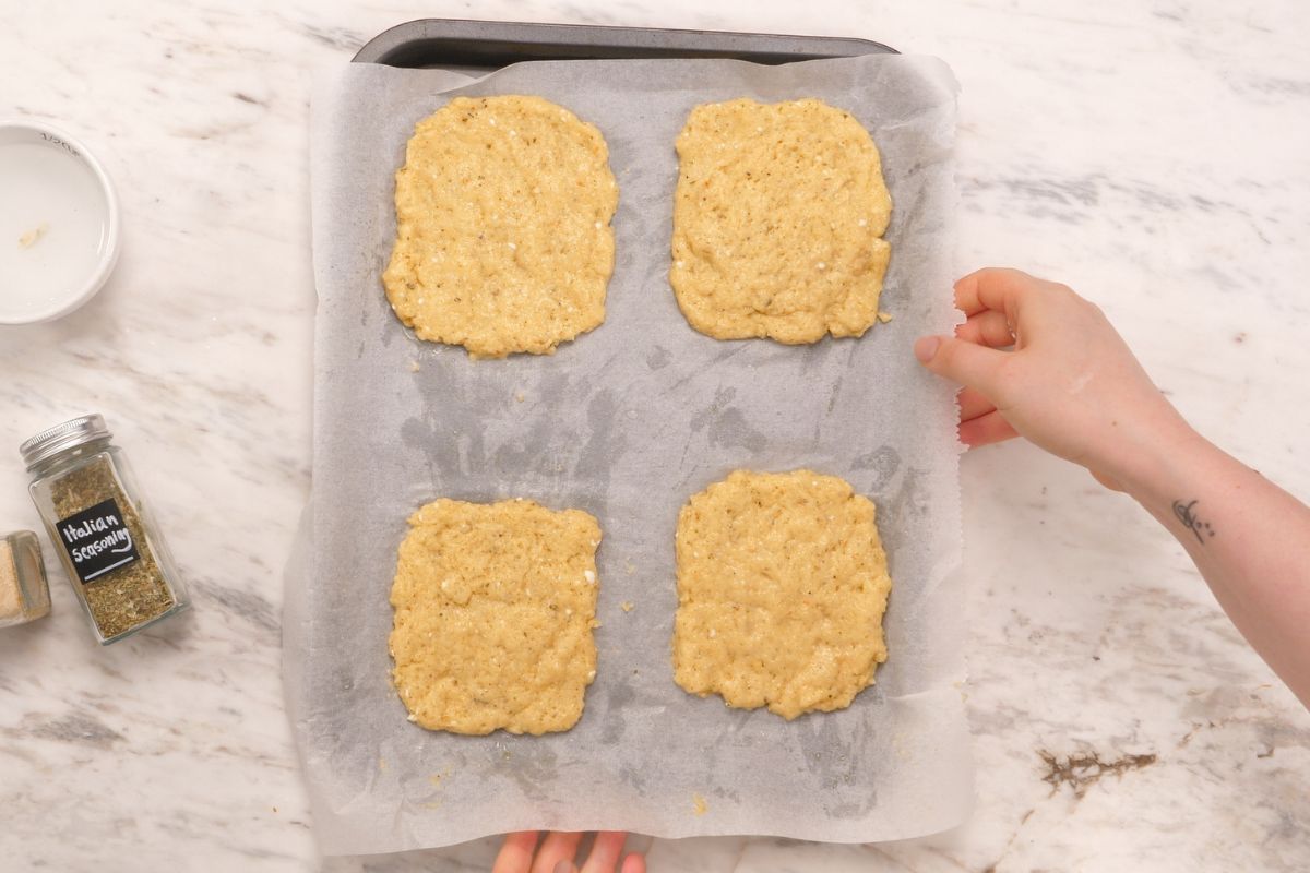 Cottage Cheese Psyllium Buns 10 Shaping cottage cheese psyllium bun batter into four portions on a parchment lined baking sheet.