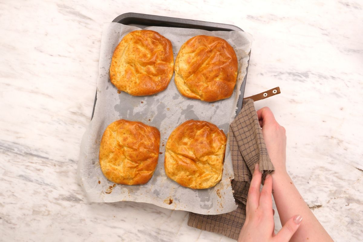 Cottage Cheese Psyllium Buns 11 Freshly baked cottage cheese psyllium buns on a parchment lined baking sheet.