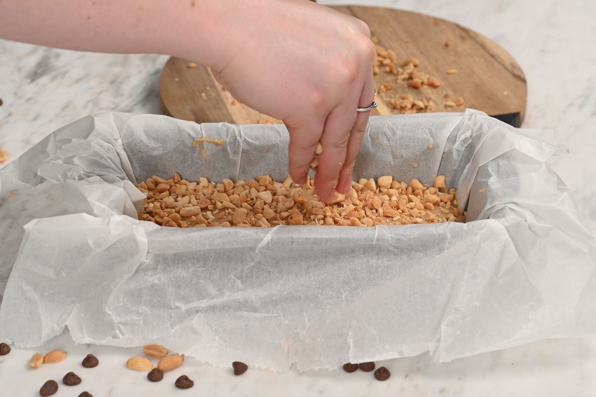 Cottage Cheese Snickers Bars 10 Sprinkling chopped peanuts over the cottage cheese layer in a parchment lined loaf pan.
