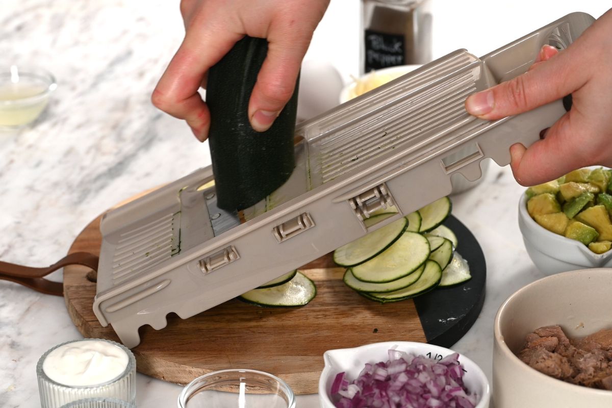 High-Protein Tuna Avocado Zucchini Tacos 5 Thinly slicing fresh zucchini with a mandoline to make zucchini taco shells.
