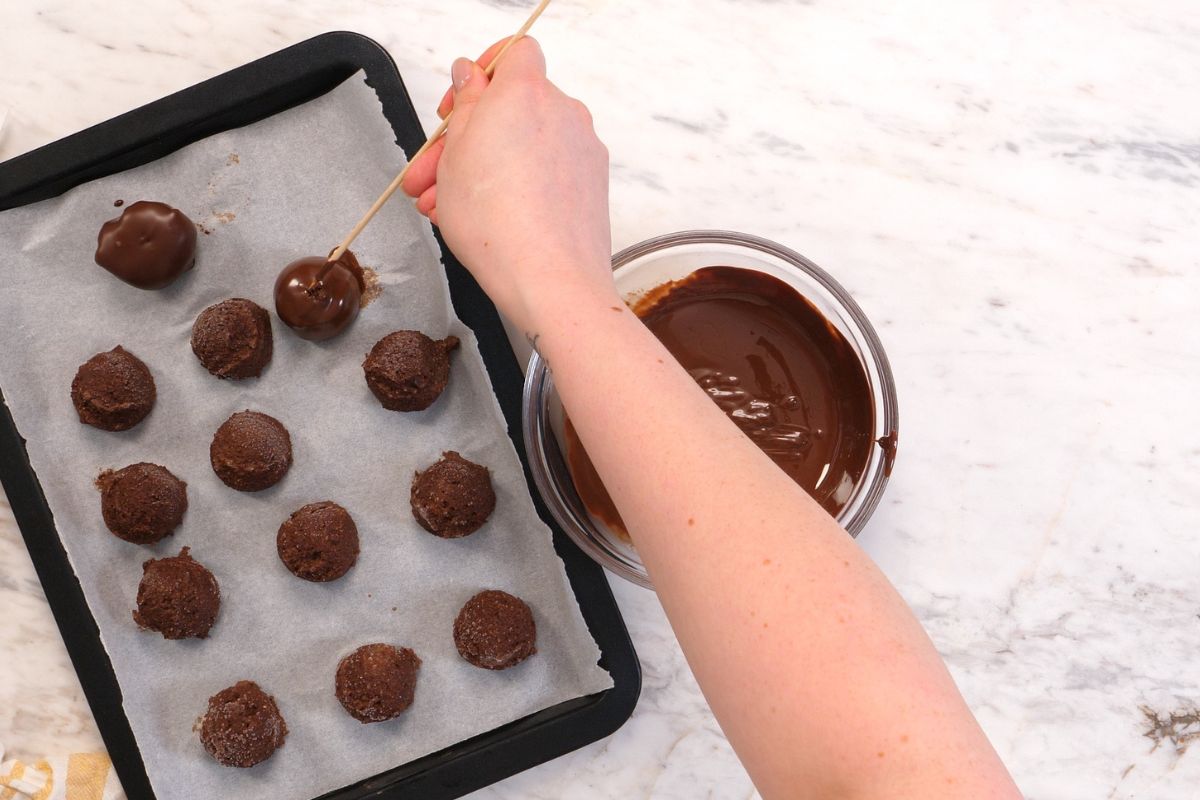 Chocolate Cottage Cheese Truffles 11 Coating the cottage cheese truffles in melted chocolate and placing them on parchment paper