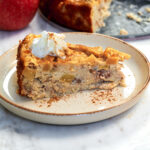 Close-up of a Cottage Cheese Apple Bake slice showing the creamy cottage cheese center, diced apples, pecans, and cinnamon.
