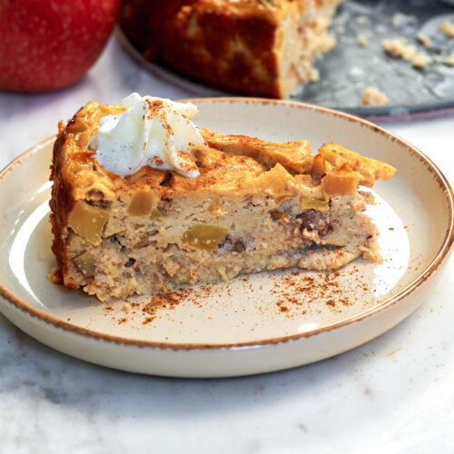 Cottage Cheese Apple Bake 14 Close-up of a Cottage Cheese Apple Bake slice showing the creamy cottage cheese center, diced apples, pecans, and cinnamon.