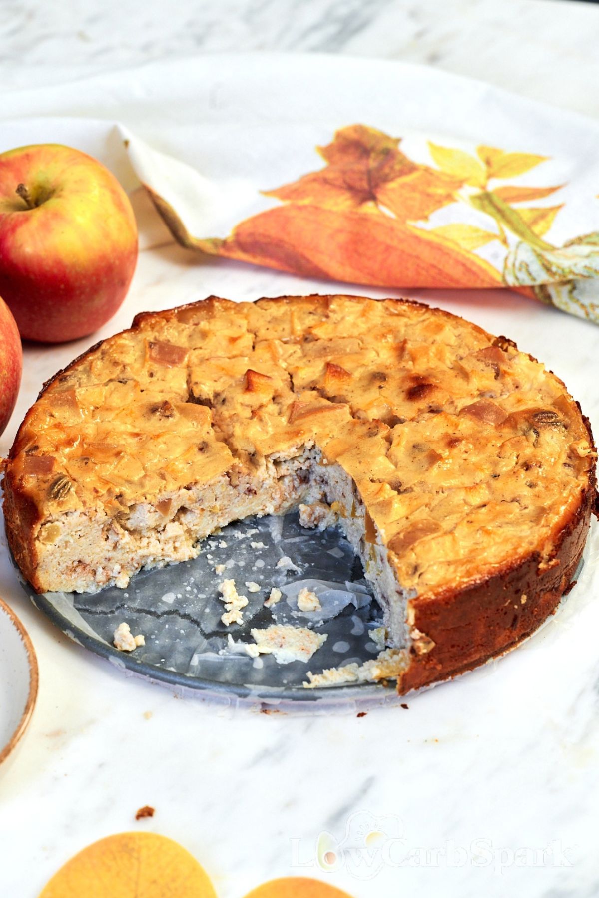 Cottage Cheese Apple Bake 12 Whole Cottage Cheese Apple Bake with a slice removed, showing the soft creamy center with tender apple pieces and pecans.