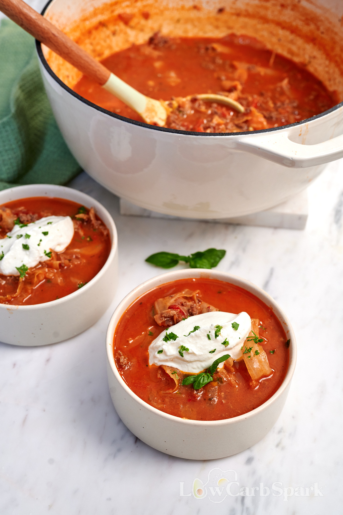 High-Protein Cabbage Lasagna Soup 14 High-Protein Cabbage Lasagna Soup served in bowls with creamy cottage cheese and fresh herbs, with the soup pot in the background.