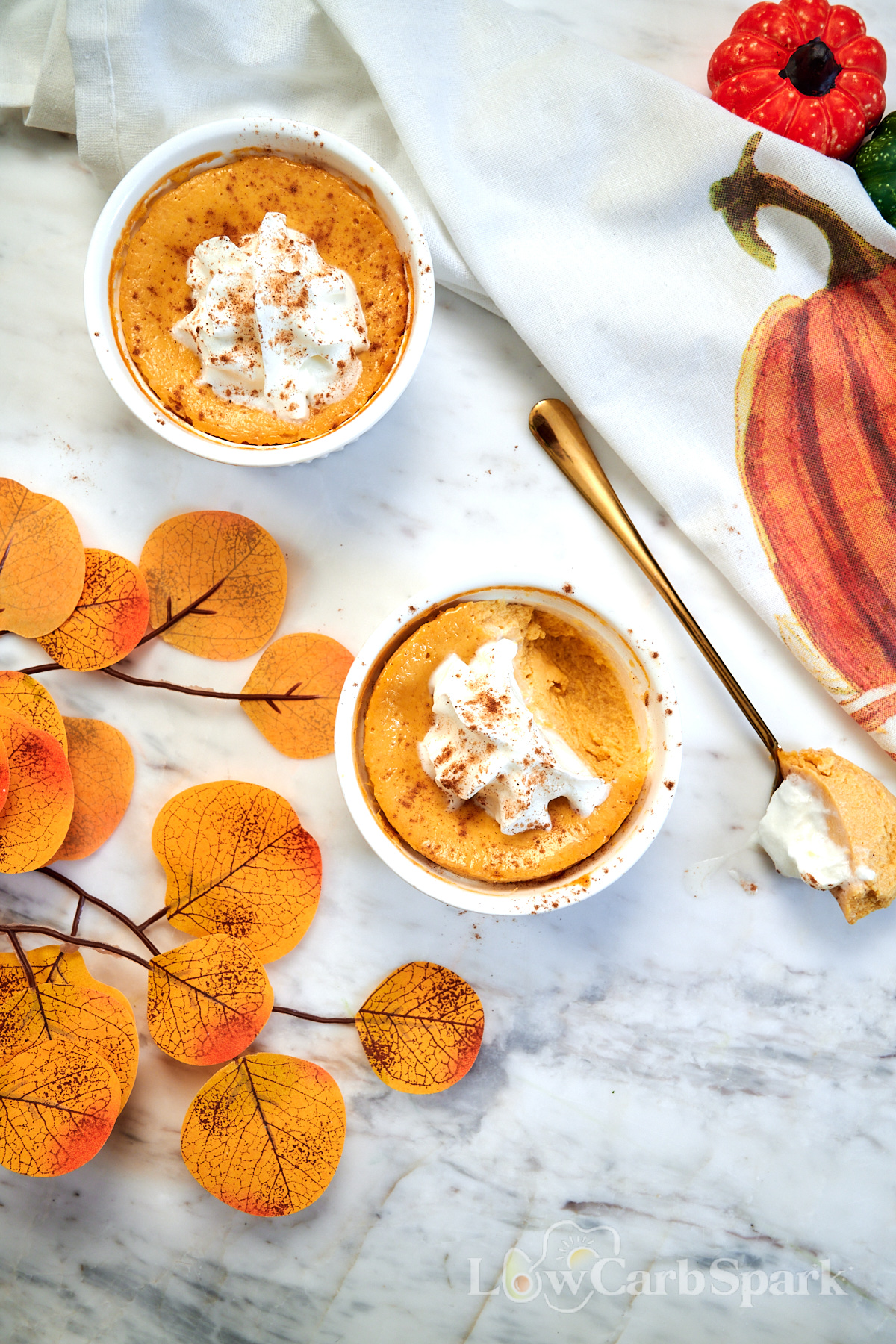 Pumpkin Protein Cheesecake for Two 9 Two pumpkin protein cheesecakes topped with whipped cream in individual ramekins.